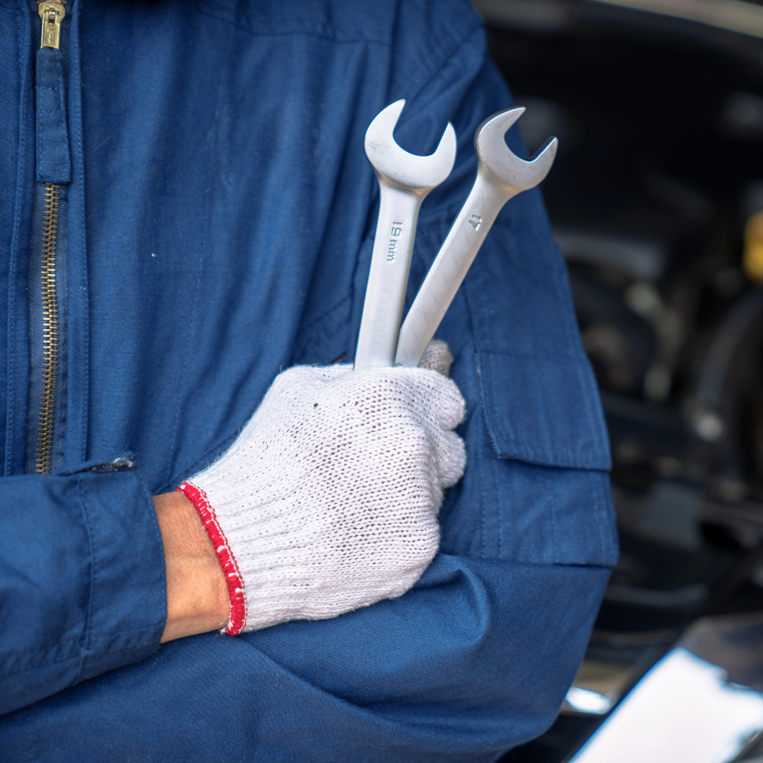 hands of man holding a wrench